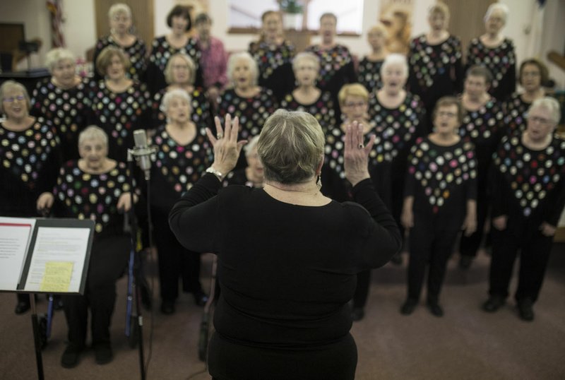 NWA Democrat-Gazette/CHARLIE KAIJO Karen Frankenfeld directs the Perfect Harmony women's barbershop chorus during a rehearsal for its 20th anniversary concert, set for Oct. 13 at Highland Christian Church in Bella Vista.