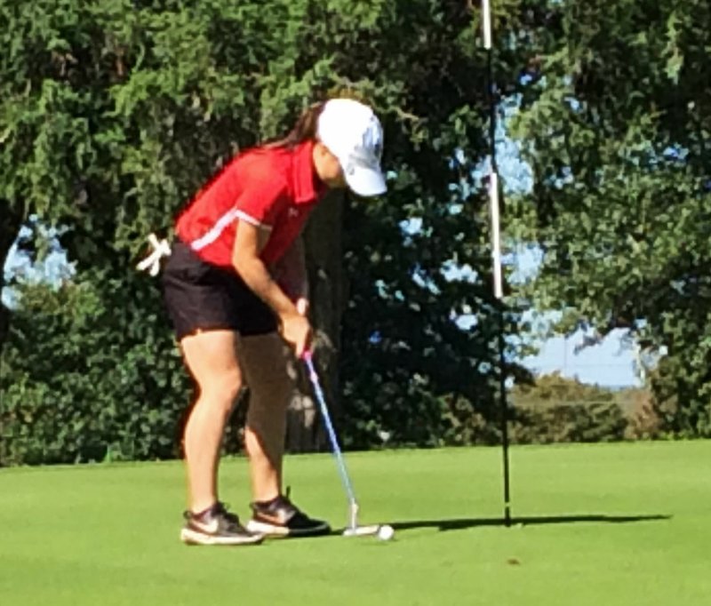 RICK PECK/SPECIAL TO MCDONALD COUNTY PRESS McDonald County's Lily Allman sinks a short put on the way to winning a share of the district championship by shooting an 82 on Oct. 7 at Schifferdecker Golf Course in Joplin.