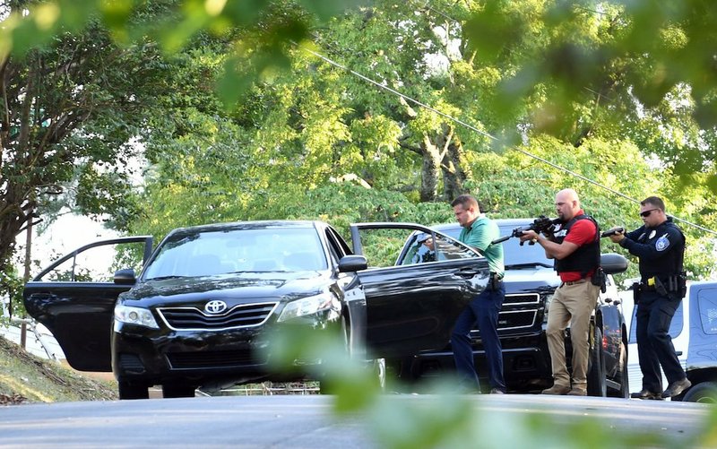 Hot Springs police officers approach a black Toyota Camry following a shooting on Sept. 10 in the 400 block of Audubon Street. - Photo by Grace Brown of The Sentinel-Record