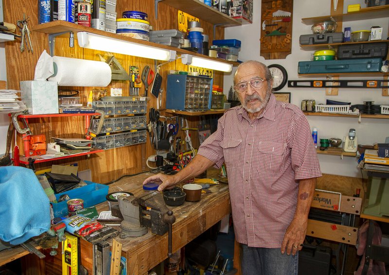 In this Oct. 9, 2019 photo, Joe Schiavone, 81, stands in his workshop in West Melbourne, Fla. Schiavone will get a modest cost-of-living increase from Social Security for 2020,a political year in which many Democrats are calling for a boost in basic benefits and a more generous formula to compute annual inflation adjustments. (AP Photo/Mike Brown)