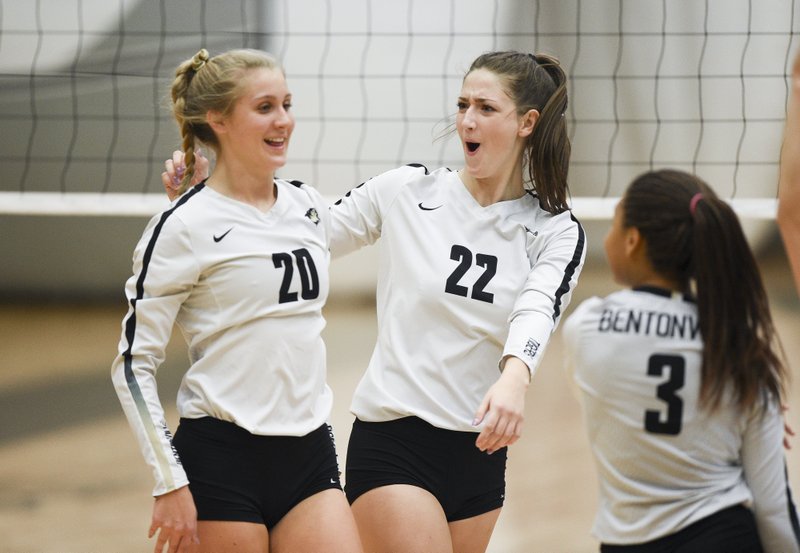 NWA Democrat-Gazette/CHARLIE KAIJO Bentonville High School Savanna Riney (20) and Maddie Breed (22) react, Thursday, October 10, 2019 during a volleyball game at Tiger Arena at Bentonville High School in Bentonville.

