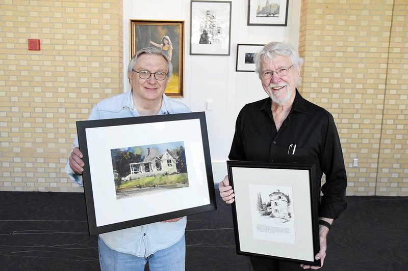 Richard Stephens, left, shows one of his watercolor paintings, Hot Springs Bungalow, while Gary Simmons shows one of his drawings, Tuscany La Palazzina. Both artworks are part of the artists’ joint exhibit that opens Tuesday at the Hot Springs Convention Center.
