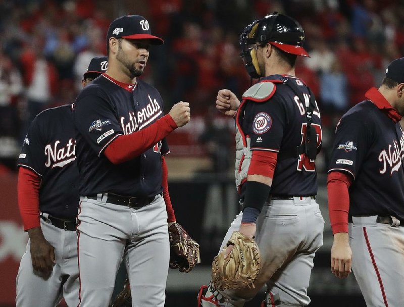 Washington Nationals pitcher Anibal Sanchez (left) is congratulated by catcher Yan Gomes as he leaves the game during the Nationals’ victory over the St. Louis Cardinals in Game 1 of the National League Championship Series on Friday. Sanchez gave up his first and only hit in the eighth inning. 