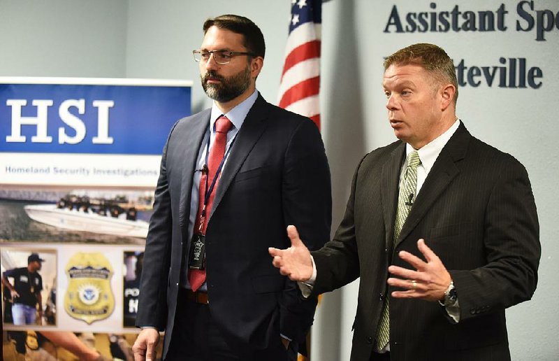 Eric Cardiel (left), Homeland Security Investigations special agent, and Nick Nelson, assistant special agent in charge, discuss details of a regional anti-counterfeiting operation at a news conference Friday at agency offices in Fayetteville. 