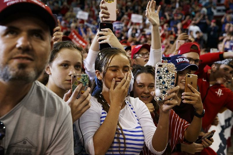 Young supporters of President Donald Trump capture the moment Friday in Lake Charles, La., as Trump arrives for a rally in support of two Republican gubernatorial candidates running against Democratic Gov. Jon Bel Edwards in today’s primary elections. 