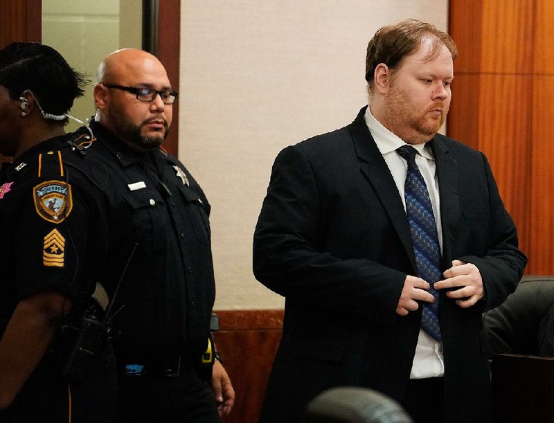 Ronald Lee Haskell is escorted into court Thursday in Houston. A jury on Friday rejected his insanity claim and sentenced him to death in six slayings, including four children. 