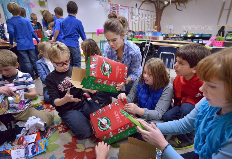 File Photo/ BEN GOFF @NWABenGoff Volunteers assemble boxes for a previous Operation Christmas Child at Life Way Christian School on the campus of First Baptist Church in Centerton. Donors are being sought to meet the Northwest Arkansas goal of 17,000 shoeboxes this year.