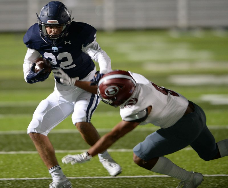 NWA Democrat-Gazette/ANDY SHUPE Har-Ber running back Max Pena (22) fends off Springdale safety Bryndell Cook (9) Friday, Oct. 11, 2019, during the first half at Wildcat Stadium in Springdale. Visit nwadg.com/photos to see more photographs from the game.