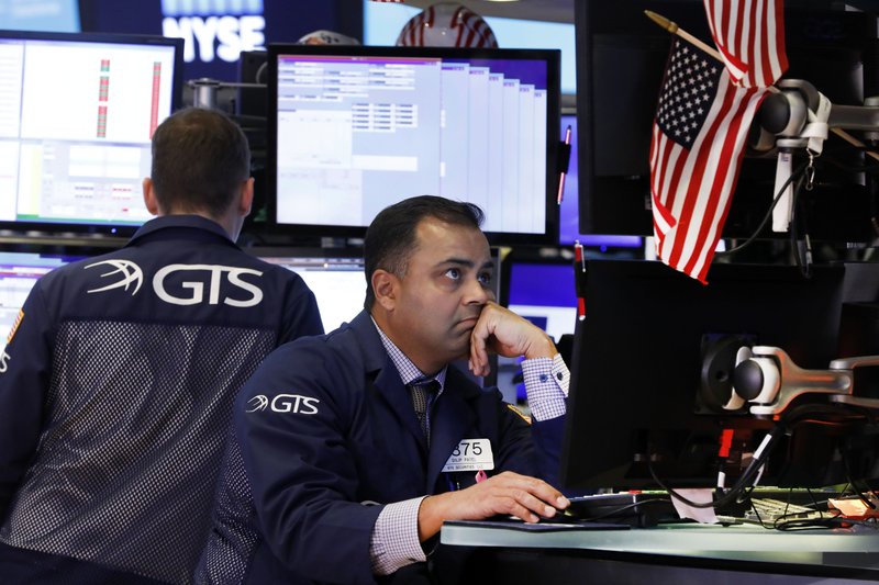 FILE - In this Oct. 2, 2019, file photo specialist Dilip Patel, right, works on the floor of the New York Stock Exchange. The U.S. stock market opens at 9:30 a.m. EDT on Friday, Oct. 11. (AP Photo/Richard Drew, File)