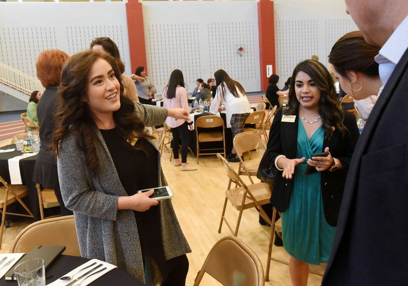 NWA Democrat-Gazette/FLIP PUTTHOFF Rebeca Soto (left) with Hispanic Women of Arkansas seats guests Friday at the group's awards luncheon at the Jones Center in Springdale. The featured speaker was Steven Dillingham, director of the U.S. Census Bureau.