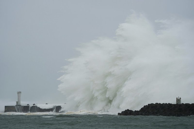 Surging waves hit against the breakwater and a lighthouse as Typhoon Hagibis approaches at a port in town of Kiho, Mie prefecture, central Japan Saturday, Oct. 12, 2019. 