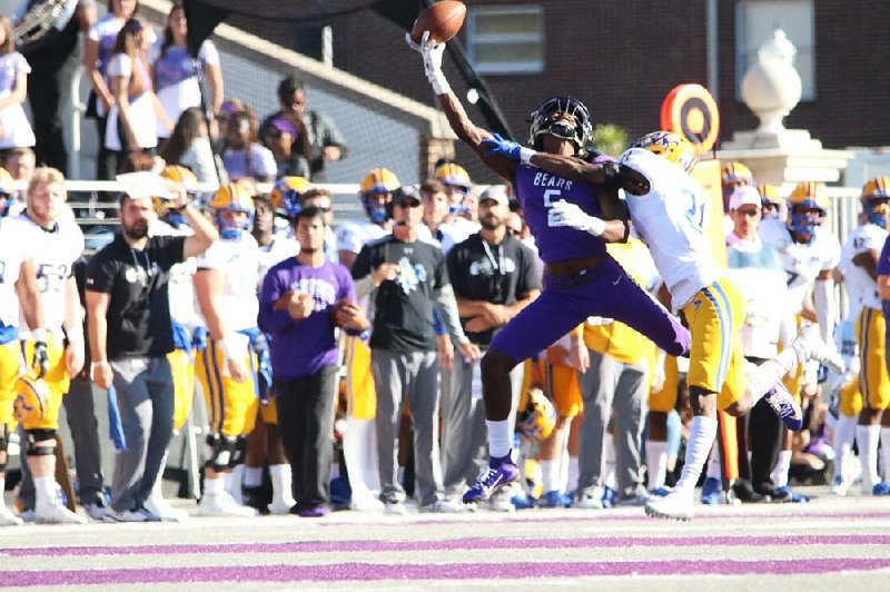 UCA receiver Lujuan Winningham makes a one-handed catch against a McNeese State defender during the Bears’ 40-31 vic- tory on Saturday at Estes Stadium in Conway.