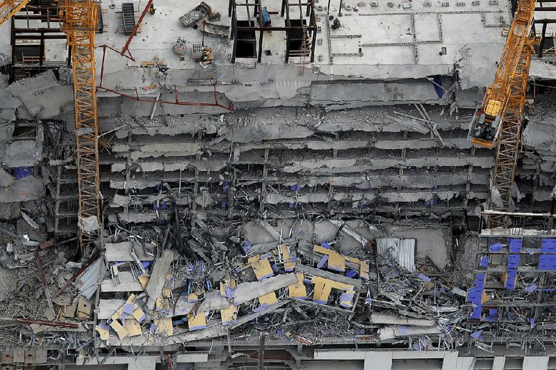This aerial photo shows the rubble after the Hard Rock Hotel that was under construction in the French Quarter in New Or- leans partially collapsed Saturday. More photos are available at arkansasonline.com/1013hotel/ 