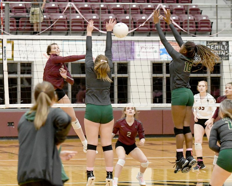 Bud Sullins/Special to Siloam Sunday Siloam Springs senior Rachel Conrad (left) hits as Alma's Kailyn Tyler and Lillie Warnock try to block during Tuesday's match at Panther Activity Center. Conrad led the Lady Panthers with 12 kills as they rallied for a 3-2 victory.