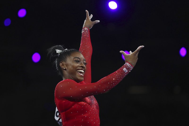 Gold medalist Simone Biles of the United States performs on the vault in the women's apparatus finals at the Gymnastics World Championships in Stuttgart, Germany, Saturday, Oct. 12, 2019. (AP Photo/Matthias Schrader)