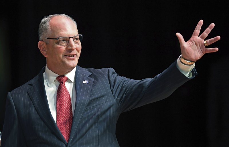 FILE - In this Sept. 19, 2019, file photo, Gov. John Bel Edwards acknowledges his supporters as he comes out onstage for a debate with Eddie Rispone and Republican Rep. Ralph Abraham in Baton Rouge, La. (Bill Feig/The Advocate via AP, Pool, File)