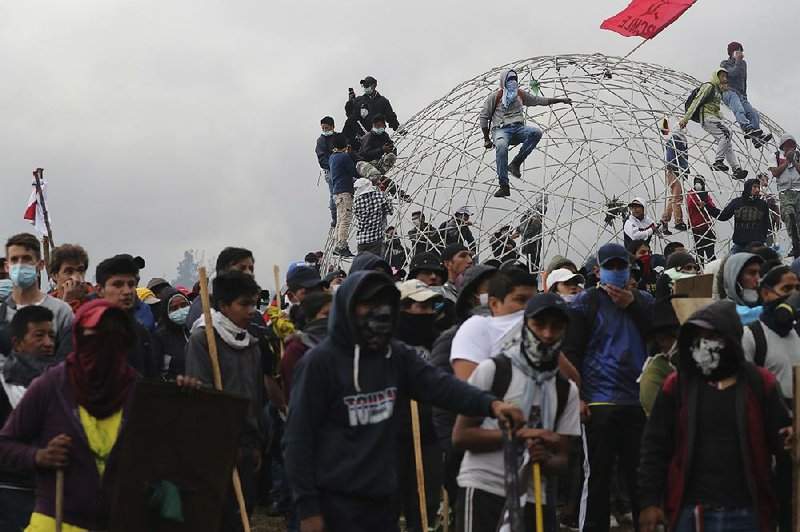 Anti-government protesters gather Sunday near the National Assembly building in Quito, Ecuador. 