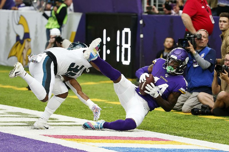 Minnesota Vikings wide receiver Stefon Diggs catches an 11-yard touchdown pass in front of Philadelphia Eagles defensive back Craig James during the second half Sunday in Minneapolis. Diggs caught 7 passes for 167 yards and 3 touchdowns as Minnesota won 38-20.