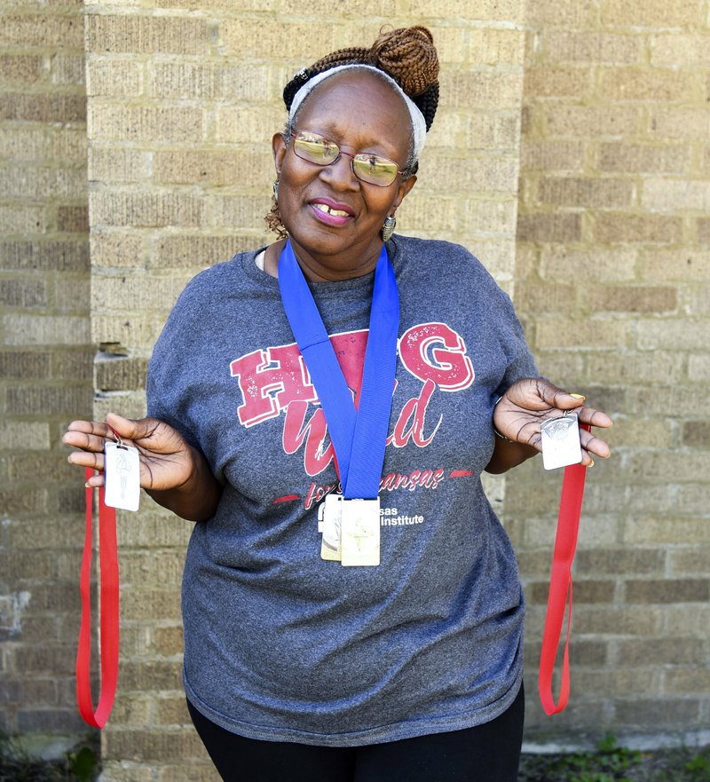 Maxine Dickerson of Hot Springs displays the gold and silver medals she won after competing in field events at the Arkansas Senior Olympics on Oct. 7. - Photo by Grace Brown of The Sentinel-Record