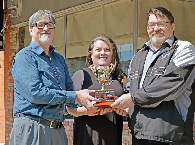 David Thompson, left, presents the Spirit of Batesville award to Kim Wilson and Steve Murphy. Wilson and Murphy have been volunteers with the Main Street Batesville haunted house since it began.