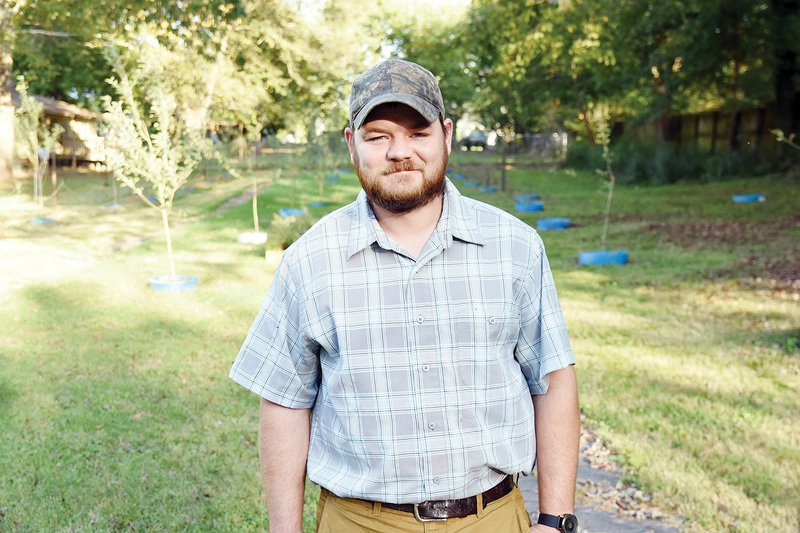 Dustin Lavender of Searcy stands in front of the Orchard Project on Vine Street. The project was started by Lavender and his wife, Rachel, to help people who need food. The Orchard Project will host its second Apple Pressing Day on Oct. 27 to make apple cider for people in the community.