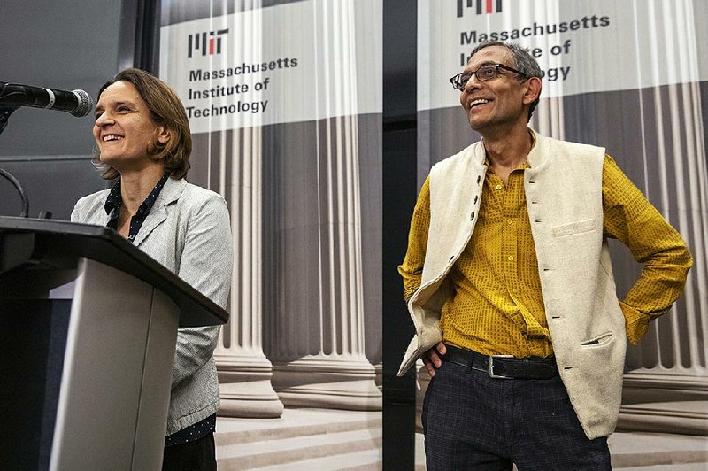 Esther Duflo (left) and Abhijit Banerjee, two of the three researchers honored for their work on alleviating poverty, speak at a news conference Monday at the Massachusetts Institute of Technology in Cambridge. More photos are available at arkansasonline.com/1015prize/ 