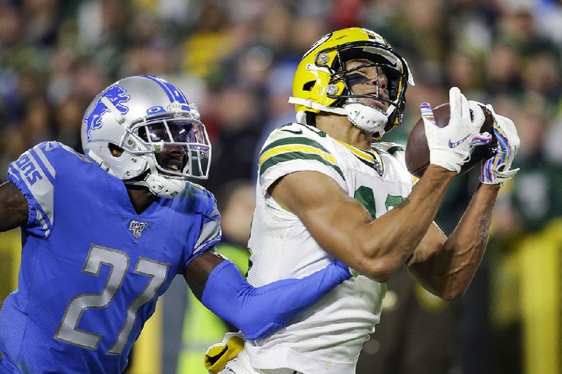 Green Bay Packers wide receiver Allen Lazard catches a touchdown pass while covered by Detroit Lions cornerback Justin Coleman during the second half Monday in Green Bay, Wis. The Packers rallied for a 23-22 victory.