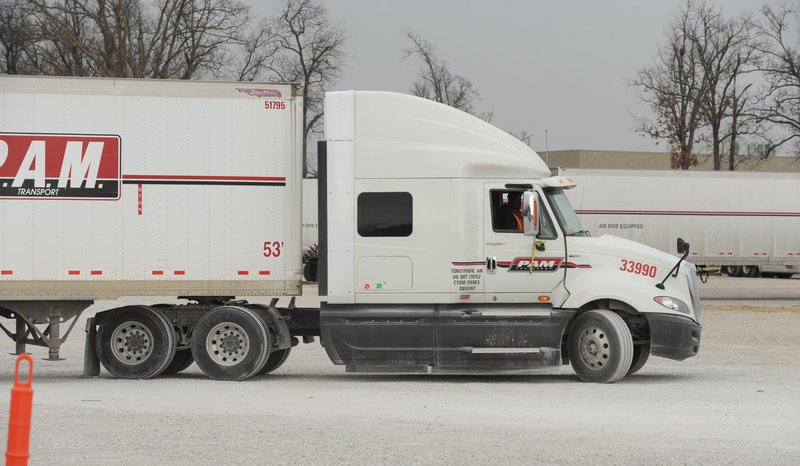 A driver in training pilots one of P.A.M. Transports' trucks Wednesday, Feb. 11, 2015, while taking part in the company's training program in Tontitown.