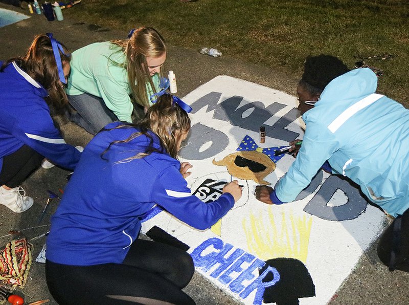 SAU students are shown competing during a past sidewalk art contest as part of homecoming week.