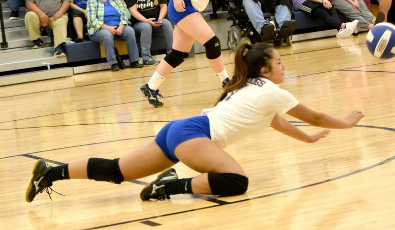 Westside Eagle Observer/MIKE ECKELS Kaylee Morales manages to dig the ball back toward the Lady Golden Arrow side of the net during the Thursday Decatur-Lavaca game at Decatur Middle School. This was Morales' final home game of her high school career.