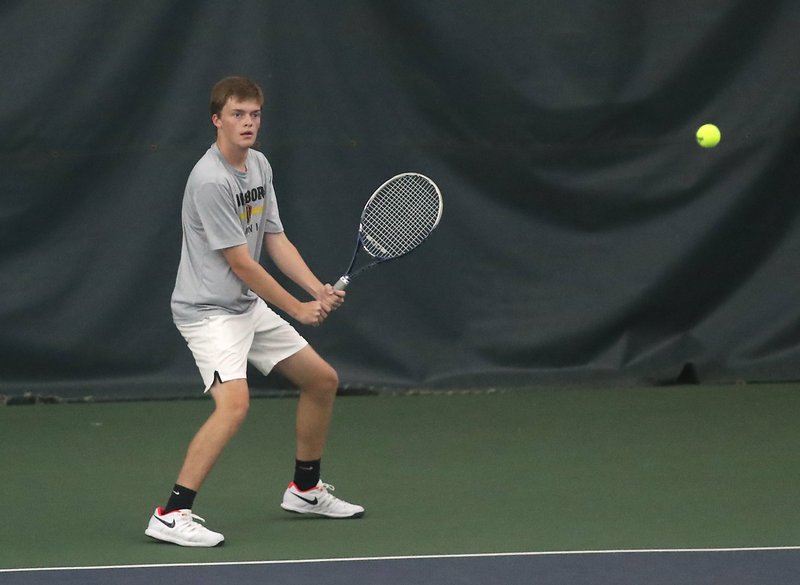 Jonesboro's Eric Richardson returns a shot to Lakeside freshman Ben Hollis in their semifinal Tuesday during the Class 5A State Tennis Tournament. Photo by Richard Rasmussen of The Sentinel-Record