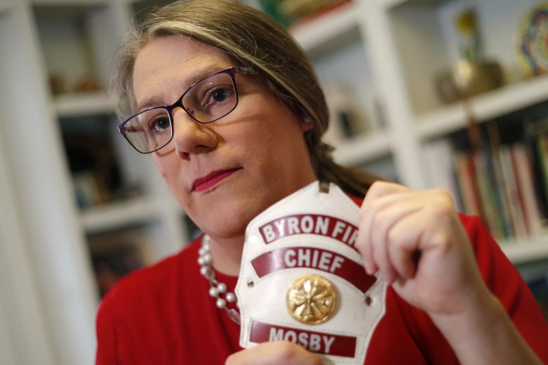 In this Sept. 26, 2019, photo, former Byron, Ga., fire chief Rachel Mosby poses for a photo in the home of a friend in Atlanta. Mosby is a transgender woman who held the job for more than a decade as a man, then was fired in June, 18 months after she openly transitioned. (AP Photo/John Bazemore)