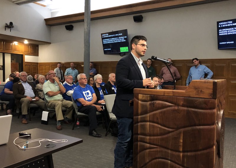 NWA Democrat-Gazette/STACY RYBURN Sam Niccum, executive broker for Riverwood Homes, speaks Tuesday at City Hall about a proposal dictating driveway widths in certain zoning districts. Several home builders and real estate professionals spoke against the proposal.