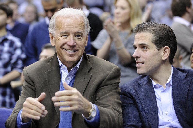 FILE - In this Jan. 30, 2010, file photo, Vice President Joe Biden, left, with his son Hunter, right, at the Duke Georgetown NCAA college basketball game in Washington. Since the early days of the United States, leading politicians have had to contend with awkward problems posed by their family members. Joe Biden is the latest prominent politician to navigate this tricky terrain. (AP Photo/Nick Wass, File)