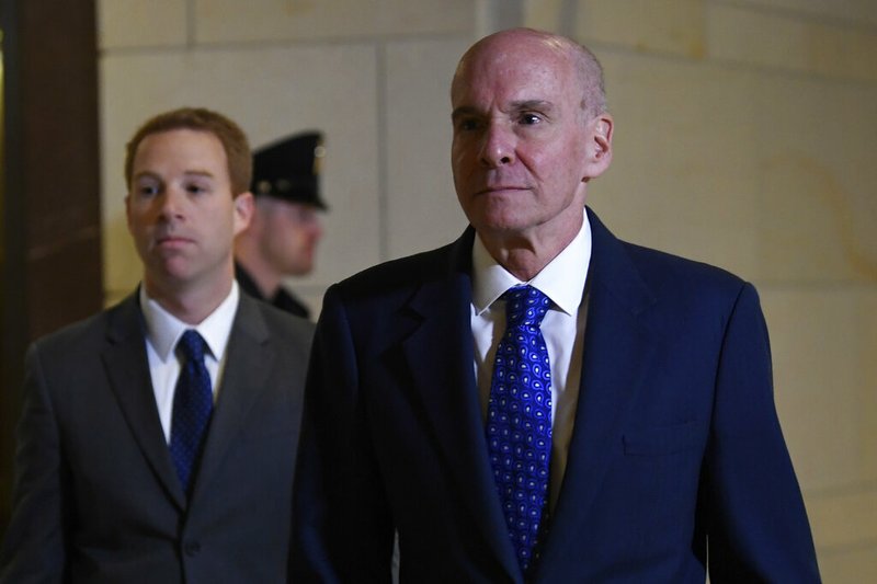 Michael McKinley, right, the top aide to Secretary of State Mike Pompeo, arrives for a joint interview with the House Committee on Foreign Affairs, House Permanent Select Committee on Intelligence, and House Committee on Oversight and Reform on Capitol Hill in Washington, Wednesday, Oct. 16, 2019. (AP Photo/Susan Walsh)