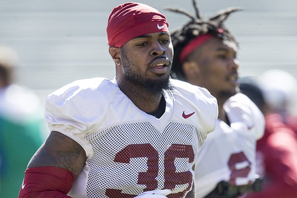 Arkansas linebacker D'Vone McClure runs onto the field for a practice Saturday, March 9, 2019, in Fayetteville.