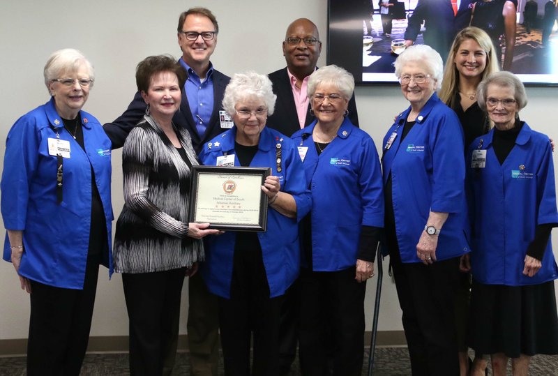 Medical Center of South Arkansas CEO Scott Street, Wayne Gibson and members of the hospital's auxiliary association pose for a photo during a reception Oct. 16, 2019. Street received administrator of the year, Gibson received the distinguished service award and the auxiliary association received an award of excellence.