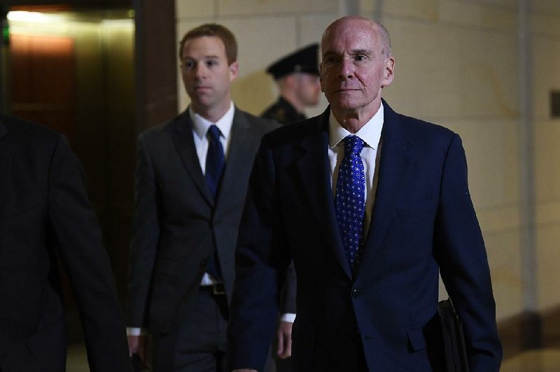 Michael McKinley (right), former top aide to Secretary of State Mike Pompeo, heads to a closed hearing Wednesday on Capitol Hill, where he reportedly testified that White House dealings with Ukraine helped spur him to retire last week after 37 years of service. More photos at arkansasonline.com/1017impeachment/ 
