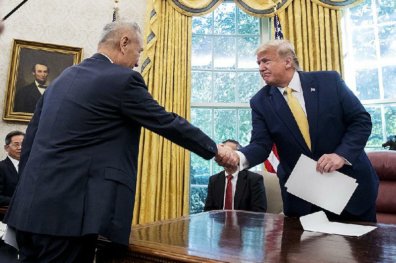 Chinese Vice Premier Liu He (left) meets with President Donald Trump at the White House on Friday after Liu and U.S. negotiators announced an agreement in the U.S.-China trade war.