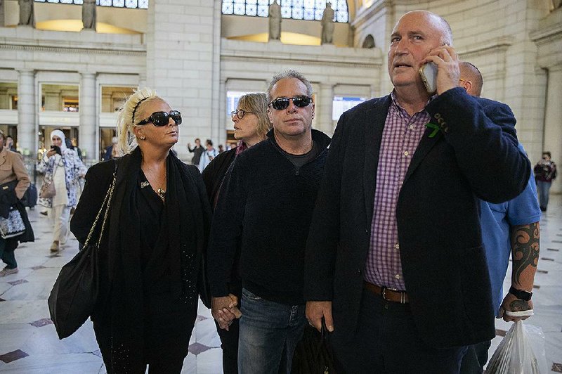 Charlotte Charles (left), mother of British teenager Harry Dunn, and her husband, Bruce Charles(center), arrive Tuesday in Washington with their spokesman Radd Seiger. 