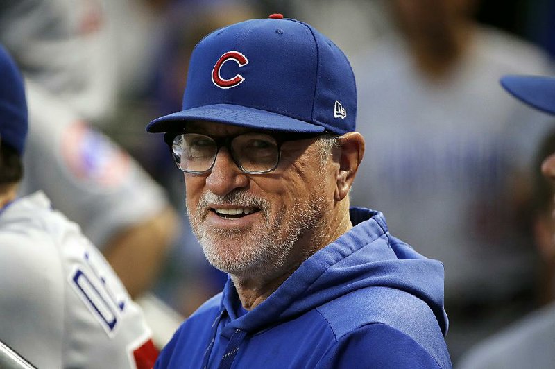  In this Sept. 25, 2019, file photo, then-Chicago Cubs manager Joe Maddon stands in the dugout before a baseball game against the Pittsburgh Pirates, in Pittsburgh. Joe Maddon has agreed to become the Los Angeles Angels' manager. 