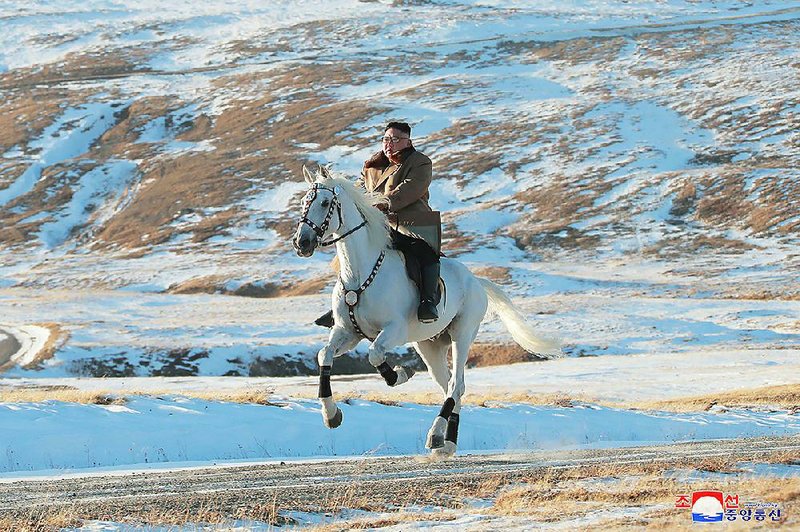 North Korean leader Kim Jong Un rides a white horse, a symbol of the Kim family, to climb Mount Paektu near his country’s border with China in this undated photo provided Wednesday. More photos are available at arkansasonline.com/1017horse/ 