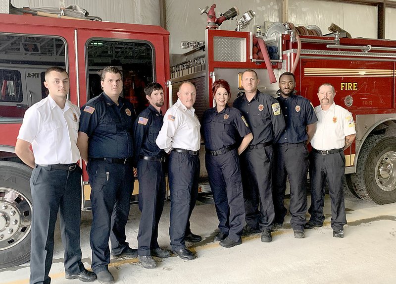 File photo/McDonald County Press The Noel Fire Department serves the small riverside town by responding to wrecks, medical calls, structure and brush fires. Firefighters are Blake Barrett (left), Dusty Schureman, Cody Miller, Chief Brandon Barrett, Cami Schureman, Trent Schureman, Aaron Jones and Eric Bennett.