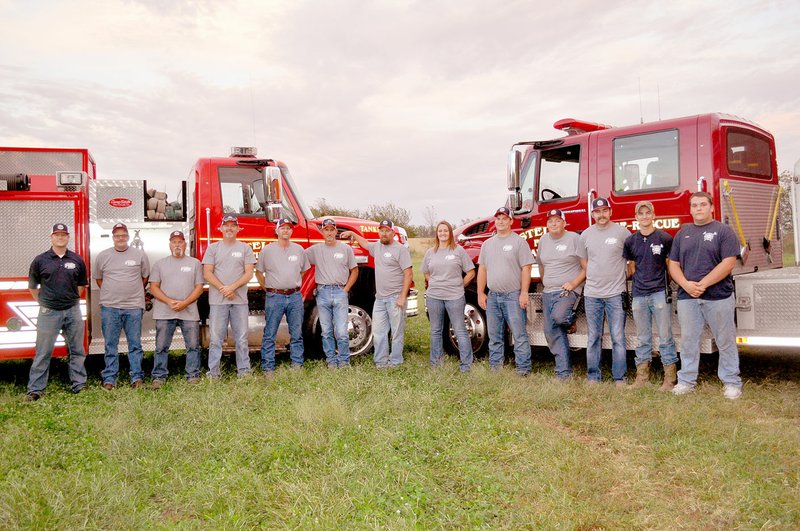 RACHEL DICKERSON/MCDONALD COUNTY PRESS Stella Rural Fire Department on Sept. 24 includes Eric Norris (left), Shawn Doty, Craig Doty, Chief Charlie Colvin, Terry Stracener, Andy Williams, Stacey Harriman, Brenna Jones, Kurt Williams, Dexter Conner, Cody Colvin, Mike Leake and Nathan Sanders.