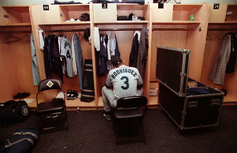 In this Oct. 5, 1997, file photo, Seattle Mariners' Alex Rodriguez sits in the locker room following their 3-1 loss to the Baltimore Orioles in Game 4 of the American League Division Series at Camden Yards in Baltimore. The Seattle Mariners are the only baseball franchise never to advance to the Fall Classic. Baseball has never been played in Seattle beyond Oct. 22.  (AP Photo/Doug Mills, File)