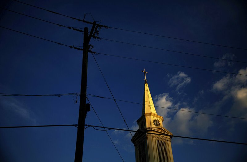 In this Tuesday, April 11, 2017 file photo, the sun sets on a Baptist church in Georgia. According to new data released Thursday, Oct. 17, 2019, by the Pew Research Center, the portion of Americans with no religious affiliation is rising significantly, in tandem with a sharp drop in the percentage that identifies as Christian. (AP Photo/David Goldman)