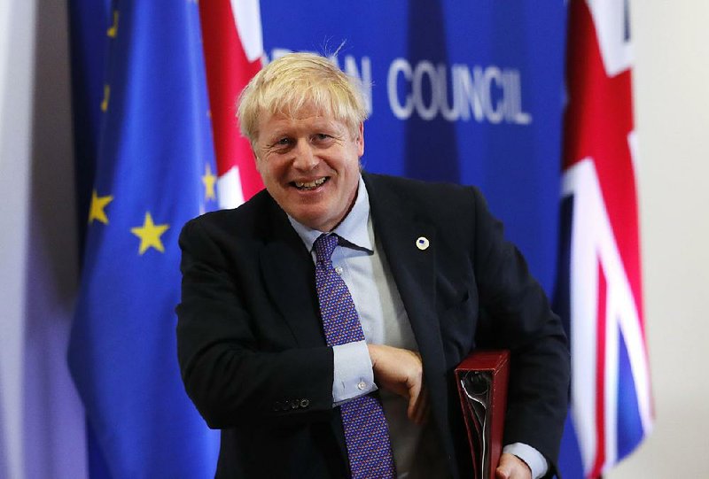 British Prime Minister Boris Johnson leaves a news conference Thursday in Brussels after announcing the tentative agreement with European Union negotiators. “This is a great deal for our country — the U.K. — and our friends in the EU,” Johnson said. More photos at arkansasonline.com/1018uk/ 