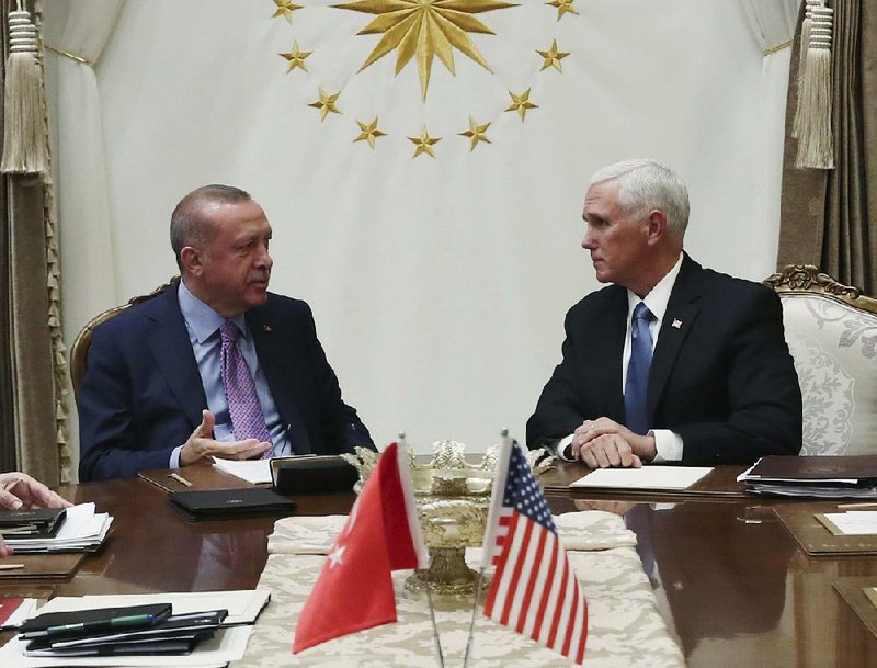 Turkish President Recep Tayyip Erdogan (left) and Vice President Mike Pence hold talks Thursday at the Presidential Palace in Ankara before Pence announced the cease-fire agreement and plans for Kurdish fighters to withdraw from northern Syria. More photos at arkansasonline.com/1018erdogan/