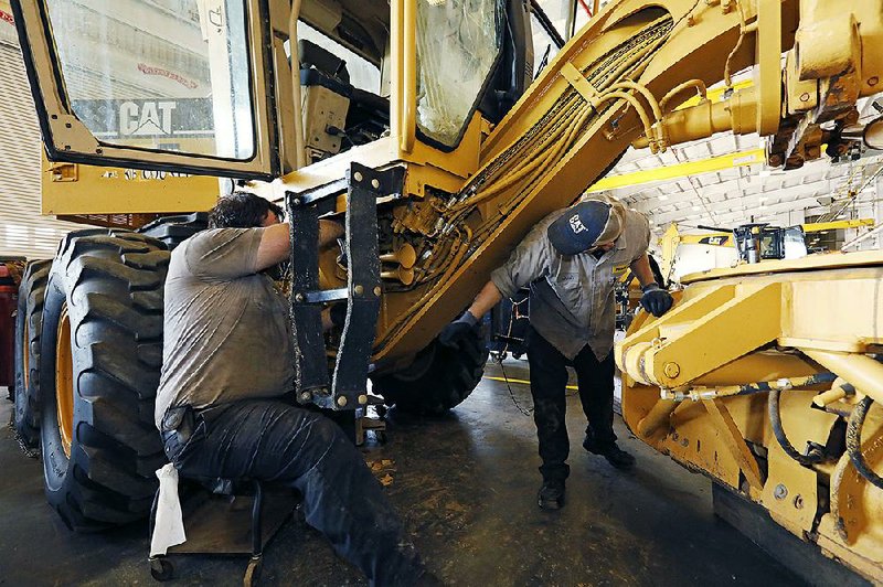 Technicians work on Caterpillar equipment in September at a dealership in Flowood, Miss. U.S. manufacturing production slumped 0.5% in September, the Federal Reserve said Thursday. 