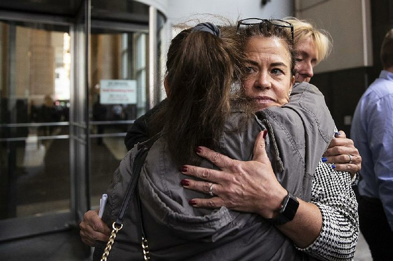 Linda Schellenger hugs supporters Thursday outside of the Stout Center for Criminal Justice in Philadelphia, after a not guilty verdict was announced in the stabbing death last July of her son, Sean Schellenger. 